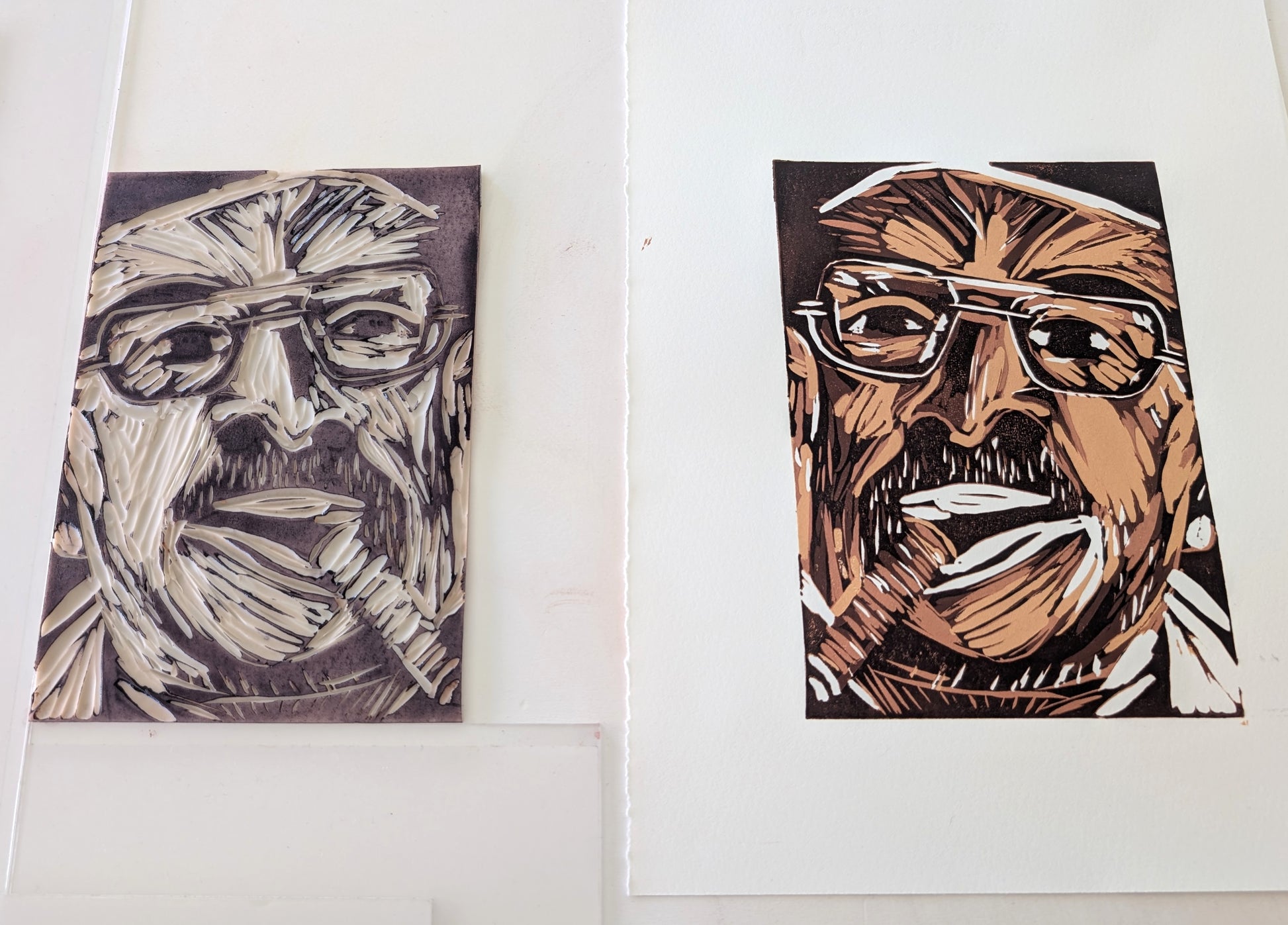 An art print of a man with glasses and a cigar, alongside the lino block which created it, on a white background.